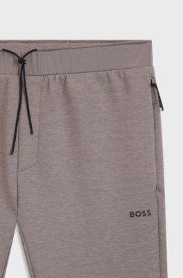Pantalones de ch&aacute;ndal regular fit con detalles reflectantes, Gris