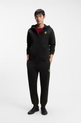 Cotton-terry tracksuit bottoms with logo artwork, Black
