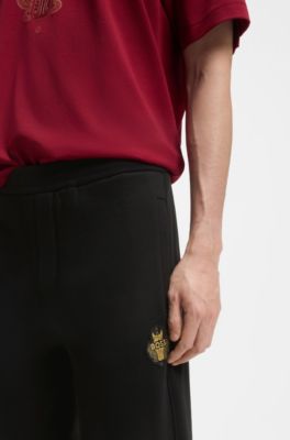 Cotton-terry tracksuit bottoms with logo artwork, Black