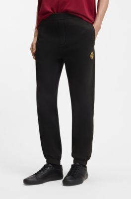 Year of the Horse Cotton-terry tracksuit bottoms with logo artwork, Black