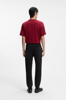 Cotton-terry tracksuit bottoms with logo artwork, Black
