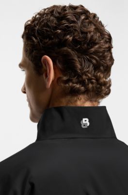 Actief, waterafstotend tweedelig trainingspak met ritsen onderaan de pijpen, Zwart