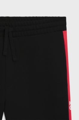 Pantalones de ch&aacute;ndal en felpa de algod&oacute;n con rayas laterales en contraste, Negro