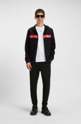 Pantalones de ch&aacute;ndal en felpa de algod&oacute;n con rayas laterales en contraste, Negro