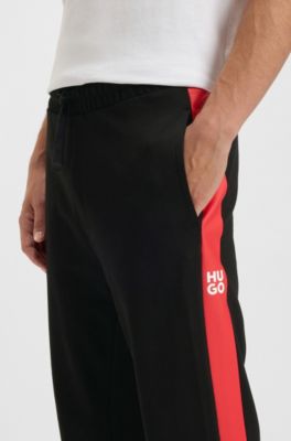 Pantalones de ch&aacute;ndal en felpa de algod&oacute;n con rayas laterales en contraste, Negro