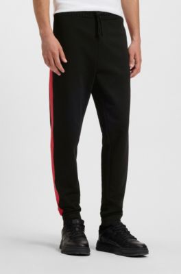 Pantalones de ch&aacute;ndal en felpa de algod&oacute;n con rayas laterales en contraste, Negro