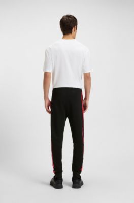 Pantalones de ch&aacute;ndal en felpa de algod&oacute;n con rayas laterales en contraste, Negro