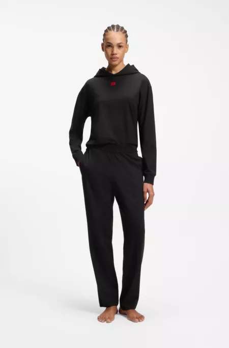 Bas de survêtement en jersey stretch avec étiquette logo rouge