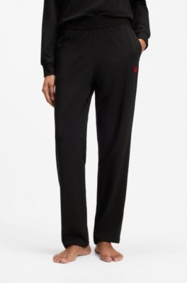 Tracksuit bottoms in stretch jersey with red logo label