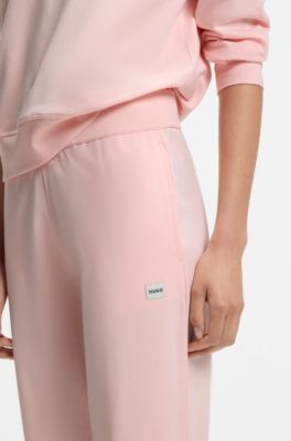 Tracksuit bottoms in stretch jersey with red logo label, Light Pink