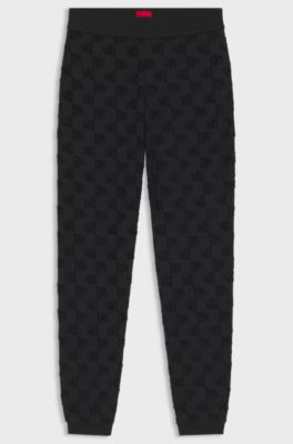 Cotton-blend tracksuit bottoms with all-over logo pattern, Black
