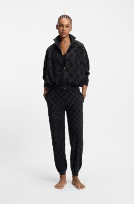 Cotton-blend tracksuit bottoms with all-over logo pattern, Black