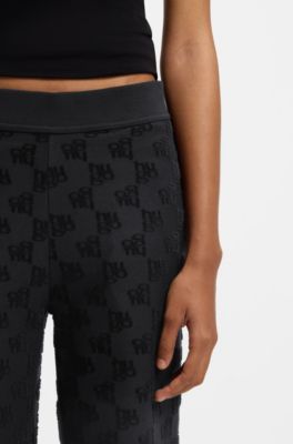 Cotton-blend tracksuit bottoms with all-over logo pattern, Black