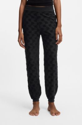 Cotton-blend tracksuit bottoms with all-over logo pattern, Black