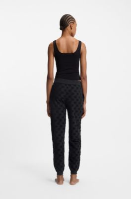 Cotton-blend tracksuit bottoms with all-over logo pattern, Black