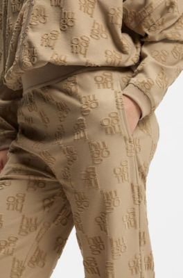 Cotton-blend tracksuit bottoms with all-over logo pattern, Light Brown