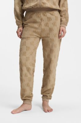 Cotton-blend tracksuit bottoms with all-over logo pattern, Light Brown