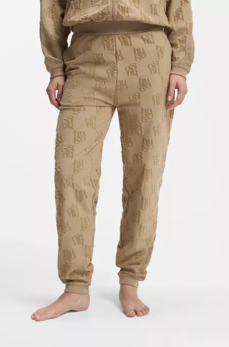 Cotton-blend tracksuit bottoms with all-over logo pattern