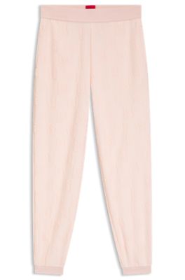 Cotton-blend tracksuit bottoms with all-over logo pattern, light pink