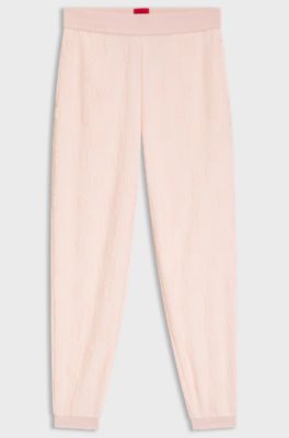 Cotton-blend tracksuit bottoms with all-over logo pattern, light pink