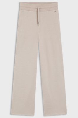 Melange-jersey tracksuit bottoms with logo plate, Light Beige