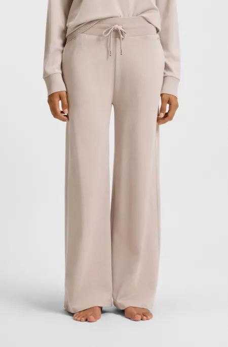 Melange-jersey tracksuit bottoms with logo plate