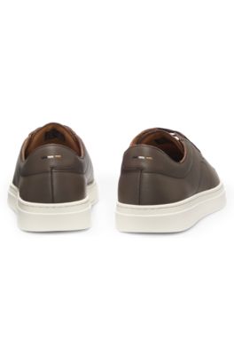 Low-top trainers in leather with embossed logo, Dark Brown