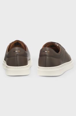 Low-top trainers in leather with embossed logo, Dark Brown