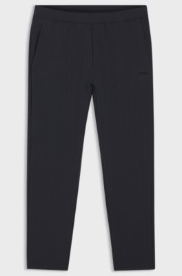 Pantalon en tissu stretch gaufr&eacute; avec fermeture &eacute;clair encadr&eacute;e et cordon de serrage, Bleu fonc&eacute;