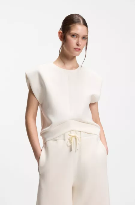 Sleeveless loose-fit sweatshirt with V-cut hemline