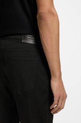 Porsche x BOSS Pantaloni con fit affusolato in denim elasticizzato, Nero