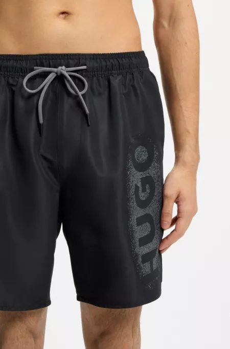 Quick-dry swim shorts with spray-effect logo