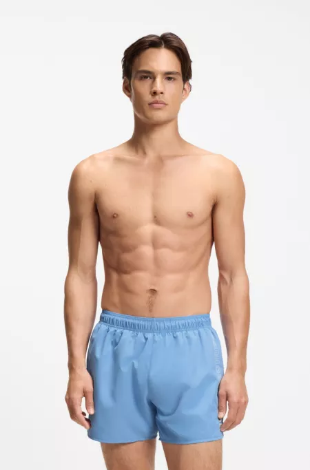 Swim shorts with repeat logos