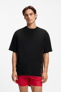 Oversized-fit T-shirt in cotton with repeat-logo print, Black