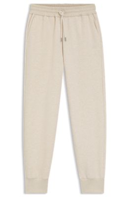 Pantalones de ch&aacute;ndal relaxed fit de algod&oacute;n con pu&ntilde;os, Blanco