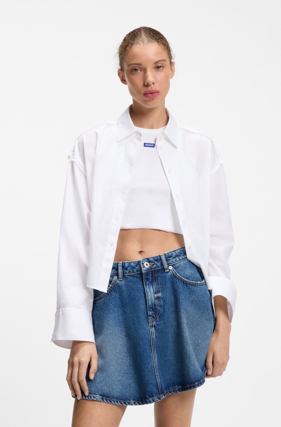 Oversize pinstriped cotton shirt with open cut hem