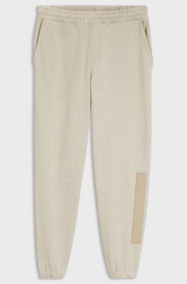 Relaxed-fit tracksuit bottoms in cotton with logo trim, Light Beige