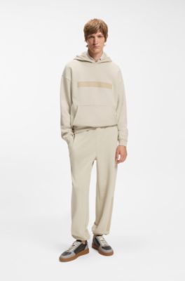 Relaxed-fit tracksuit bottoms in cotton with logo trim, Light Beige