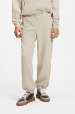 Relaxed-fit tracksuit bottoms in cotton with logo trim, Light Beige