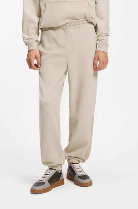Relaxed-fit tracksuit bottoms in cotton with logo trim