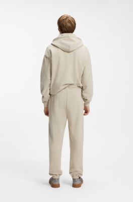 Relaxed-fit tracksuit bottoms in cotton with logo trim, Light Beige