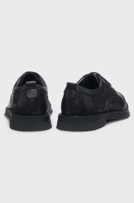 Derby shoes in leather with perforated monograms, Black