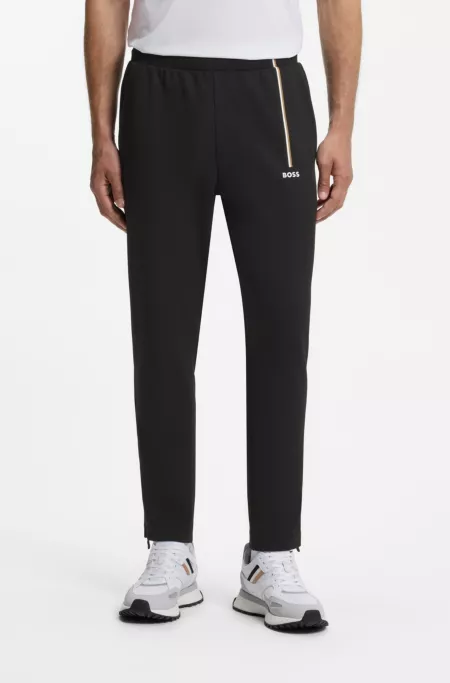 Active tracksuit bottoms in thermoregulating stretch gabardine