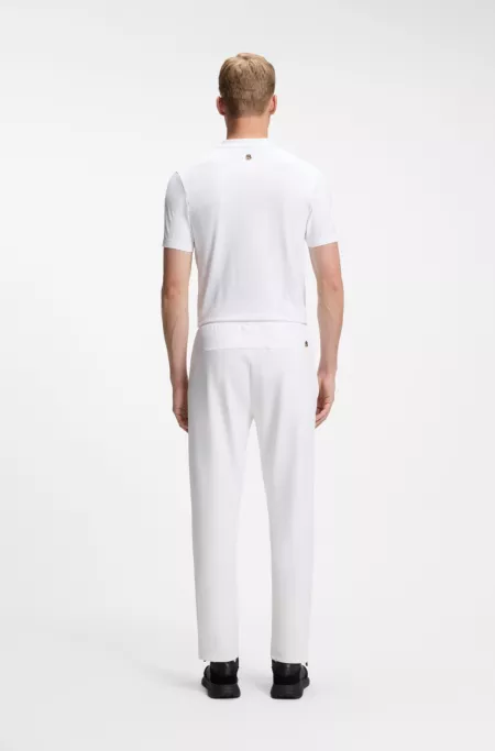 Active tracksuit bottoms in thermoregulating stretch gabardine