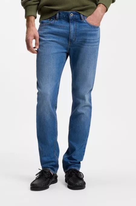 Jeans slim fit de denim elástico en azul medio