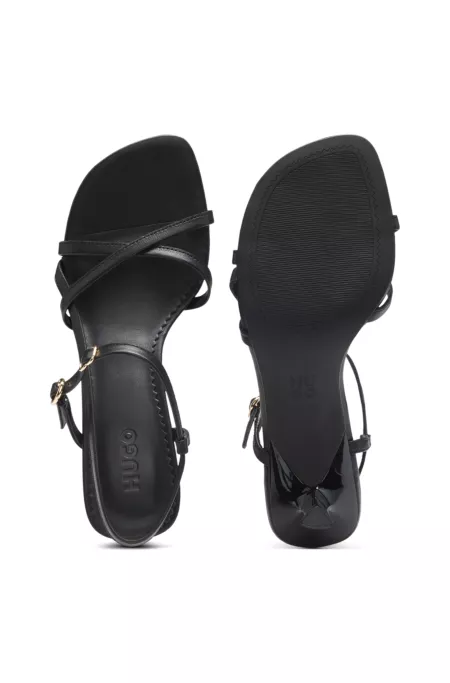 Strappy sandals in leather with asymmetric heel