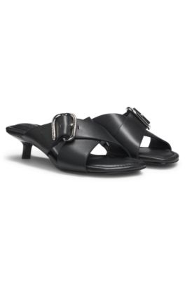 Leather mules with crossed buckled straps, Black