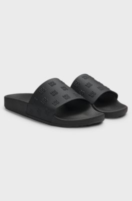 Slippers met herhaald tweedelig logo op de bovenzijde, Zwart