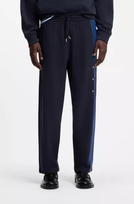 Relaxed-fit tracksuit bottoms in cotton with side stripe