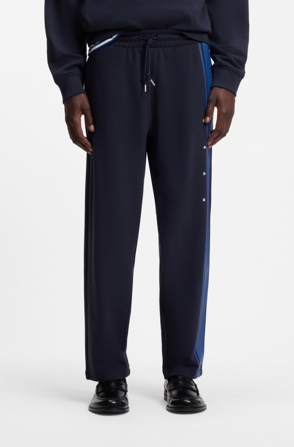 Relaxed-fit tracksuit bottoms in cotton with side stripe